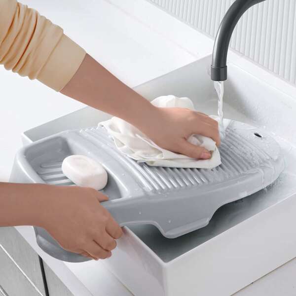 A Compact Mini Washboard For Clothes With A Corrugated Surface And Integrated Soap Holder.